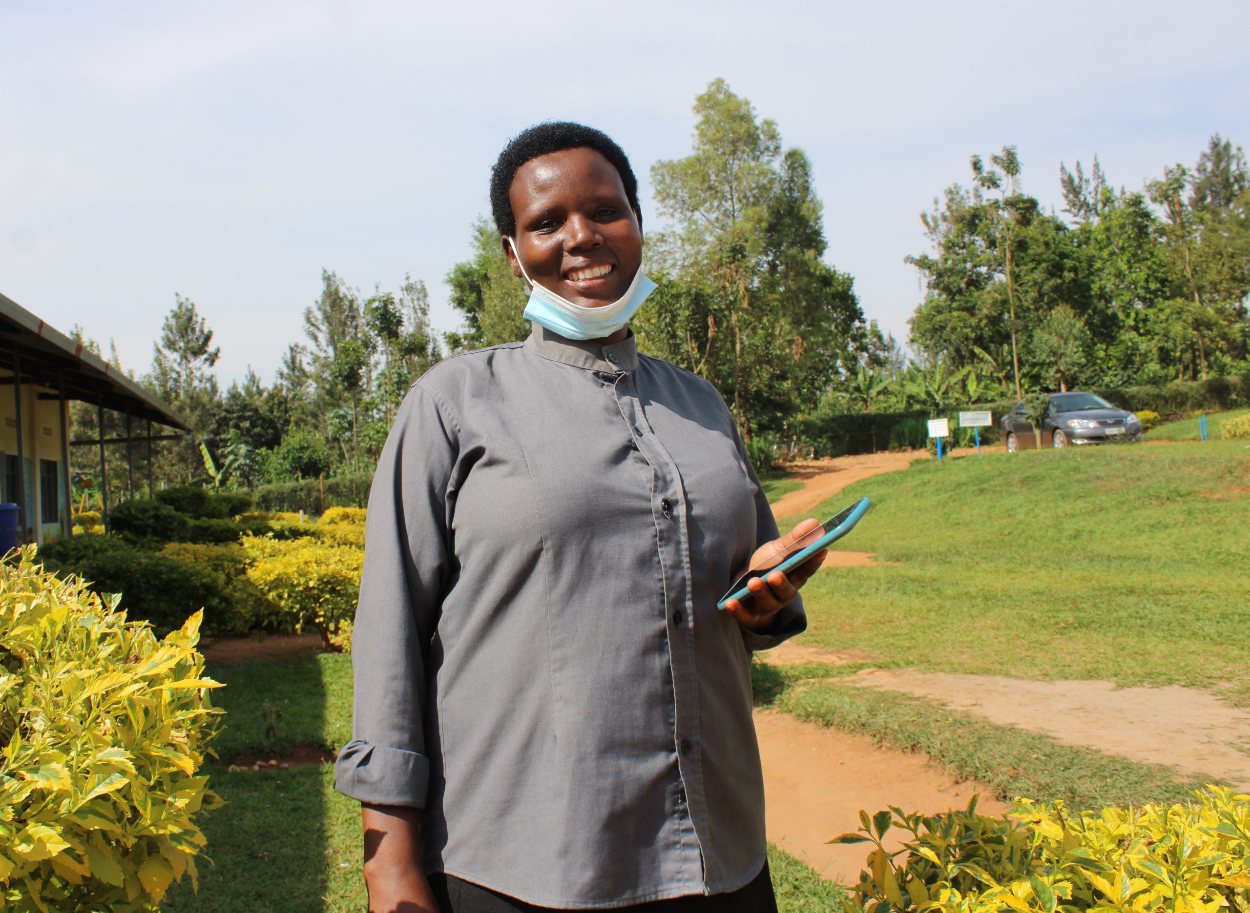 A woman smiling and holding her smartphone